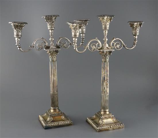 A pair of late Victorian silver corinthian column two branch, three light candelabra by Walker & Hall,(a.f.) height 45.5cm.